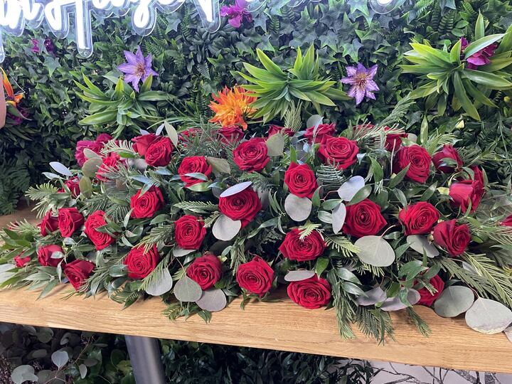 Coffin spray of red roses and white flowers