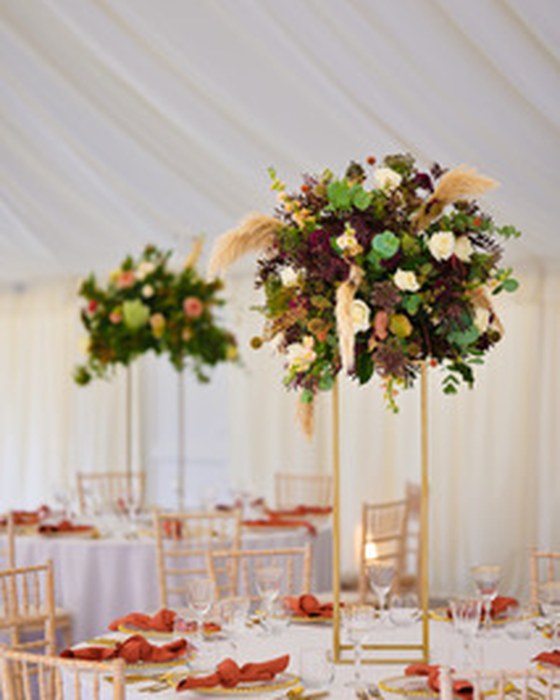 Tall centrepieces in a marquee reception